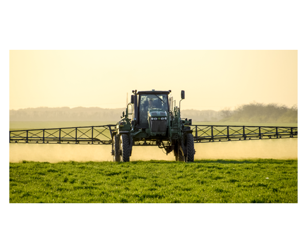 A tractor fertilizing a field.