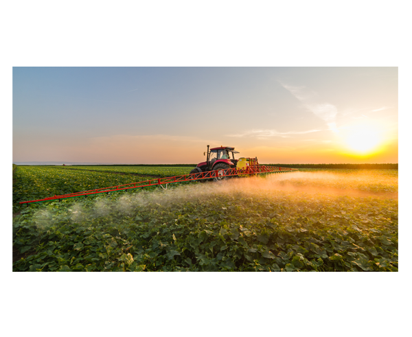 A tractor spraying fertilizer in a field.