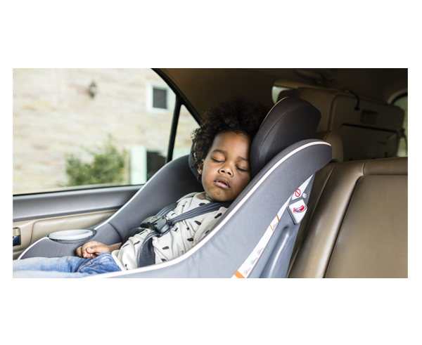 A small child asleep in a child car seat.