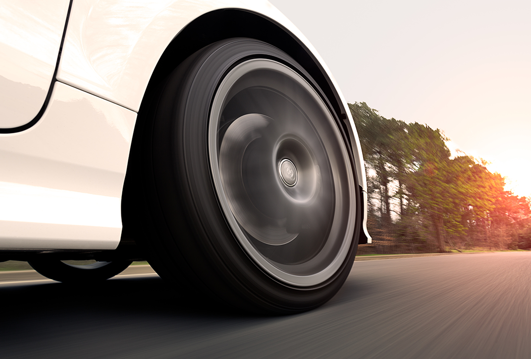 The front tire of a car in motion. The front tire of a car in motion.