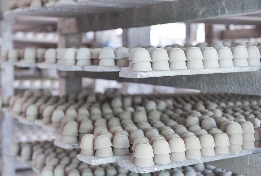 Lines of ceramic pots set out to dry