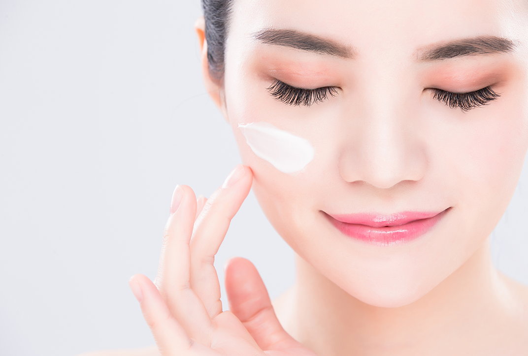 A lady applying face cream. A lady applying face cream.