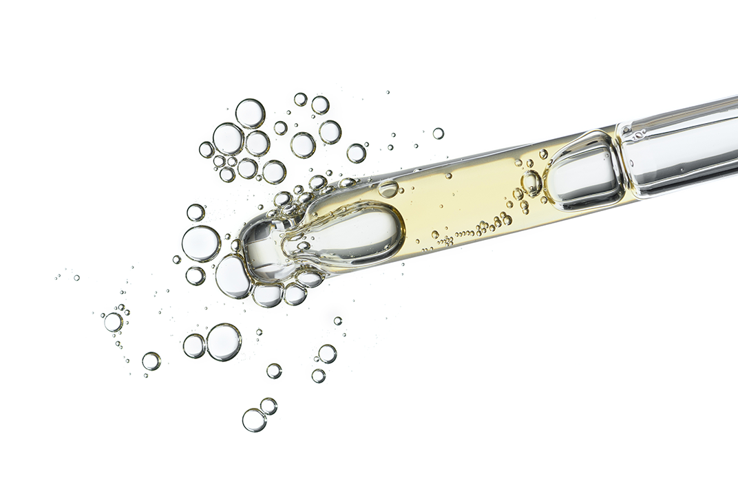 A pipette filled with liquid. A pipette filled with liquid.
