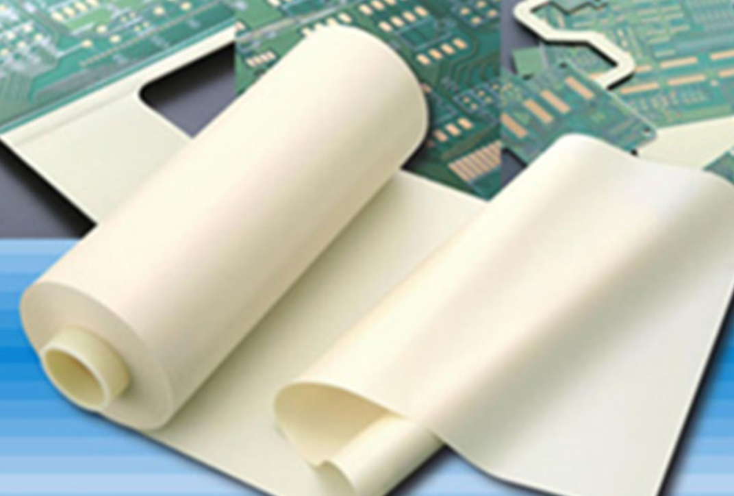 A roll of white film which is partly wound up. It is placed on some circuit boards. A roll of white film which is partly wound up. It is placed on some circuit boards.