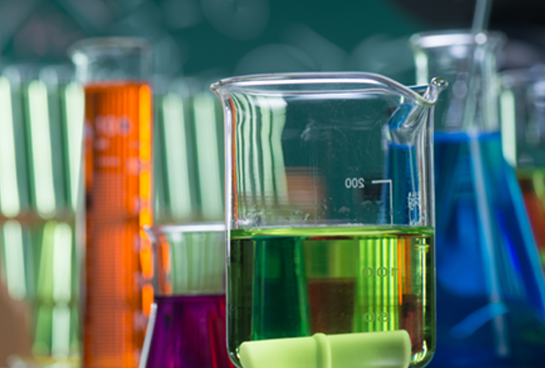 Various laboratory vessels with colored liquids.