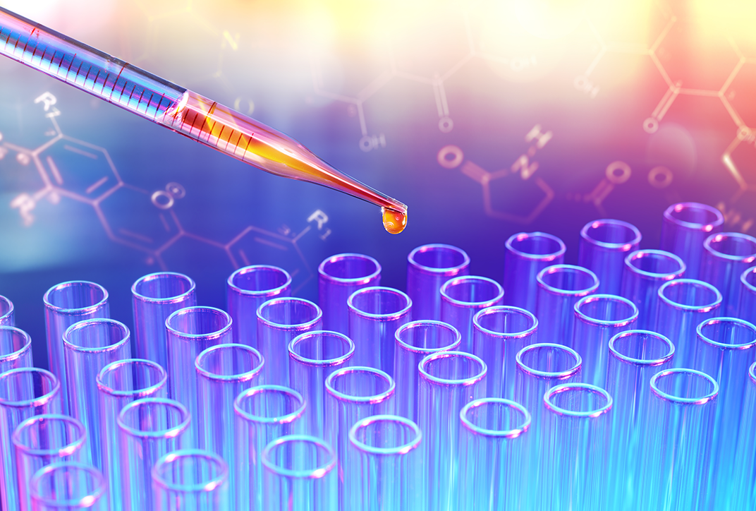A pipette filled with liquid. A pipette filled with liquid.