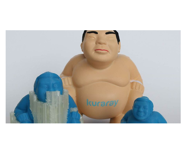 Three toy figures of sumo wrestlers.