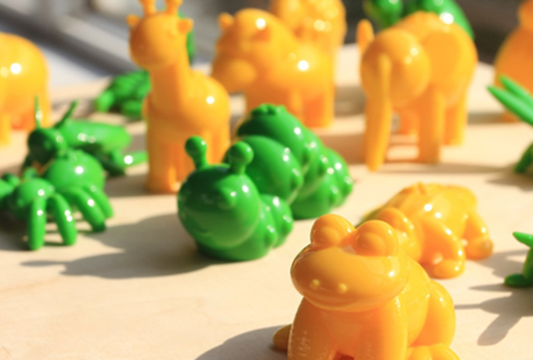 A group of green and yellow toy figures made of plastic.